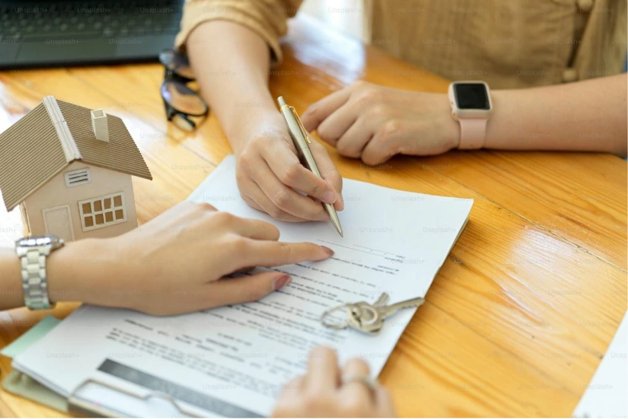 Alt: Homeowner reviewing mortgage documents while considering when to remortgage in a high interest rate market