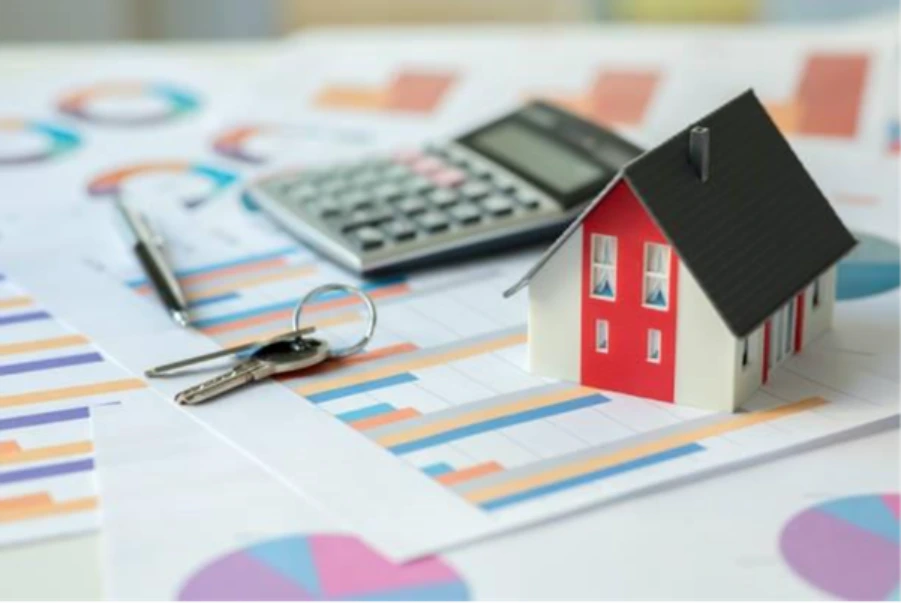 House model and calculator on mortgage rate charts representing whole of market comparison